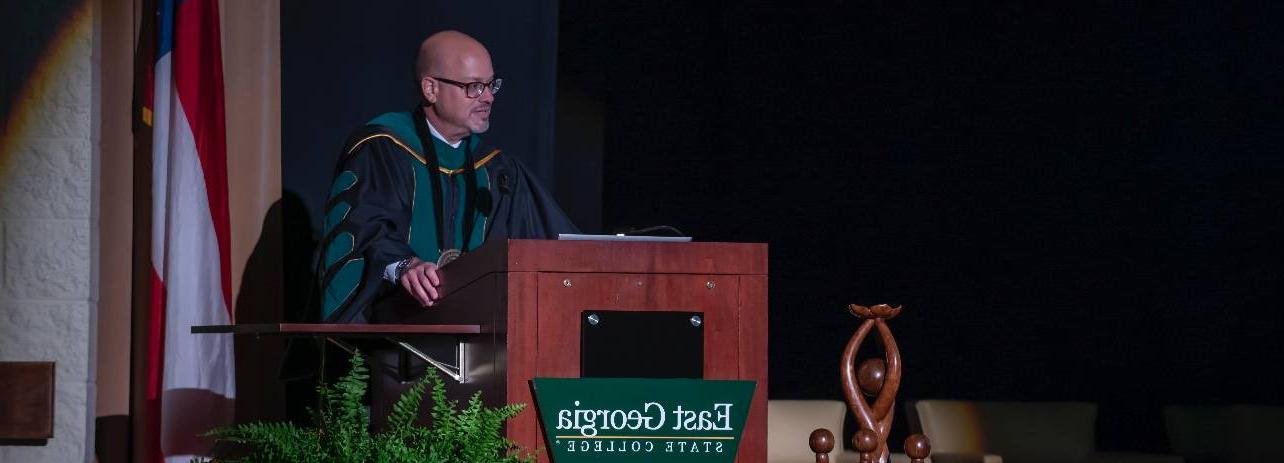 Dr. David Schecter stands behind a podium